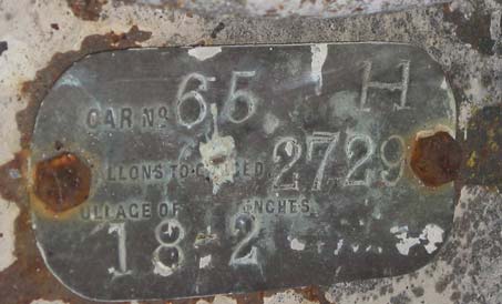 Metal label attached to the inside face of the filler port